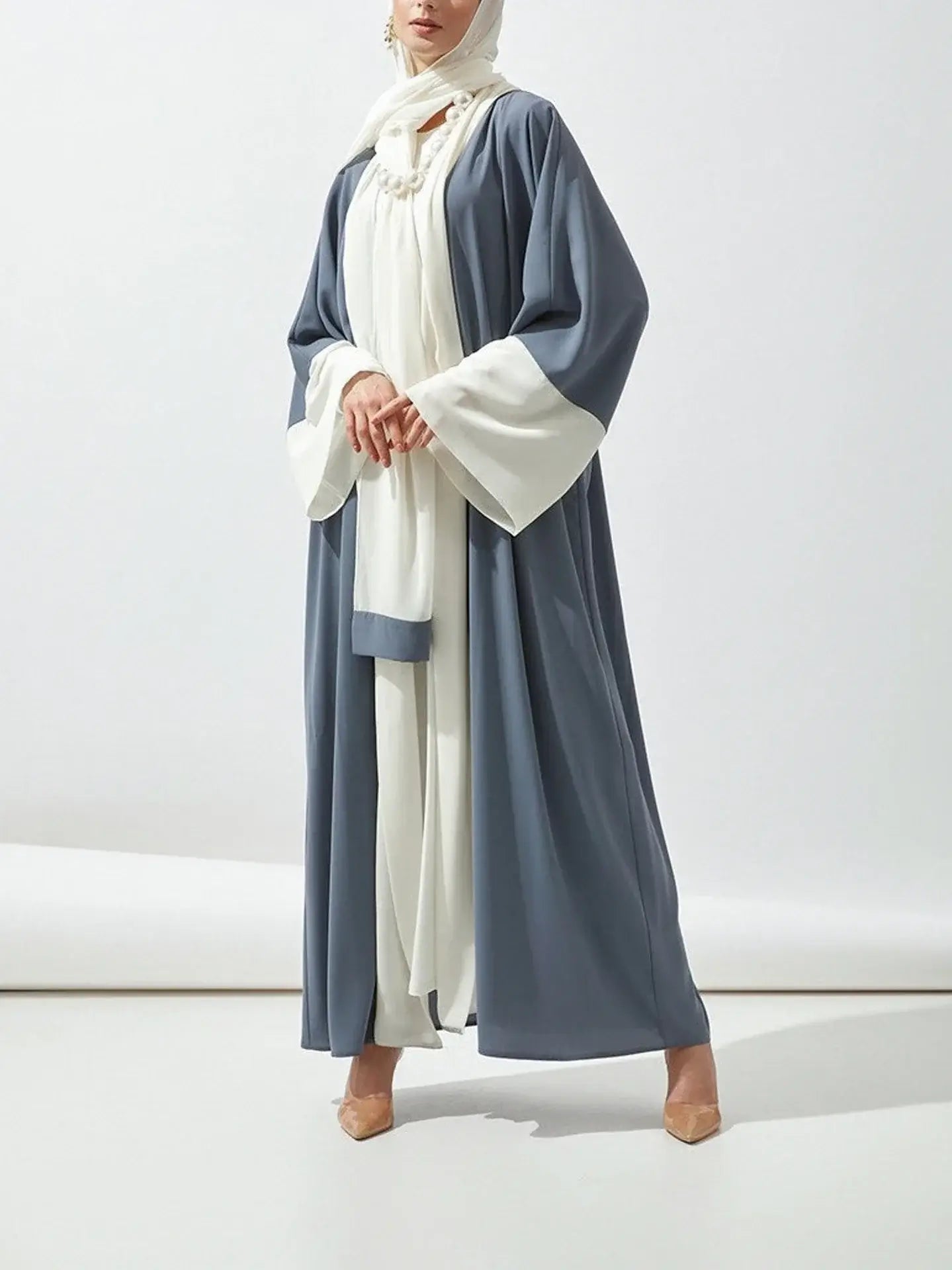 Middle-aged woman wearing a casual two-tone abaya dress with a slight stretch, made of polyester broadcloth for all seasons.