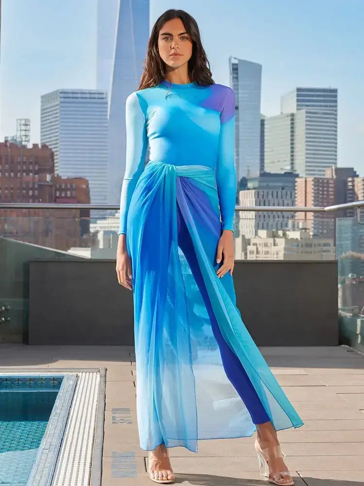 Woman wearing a blue Muslim modest long sleeve burkini swimsuit four-piece set with cityscape background near a pool