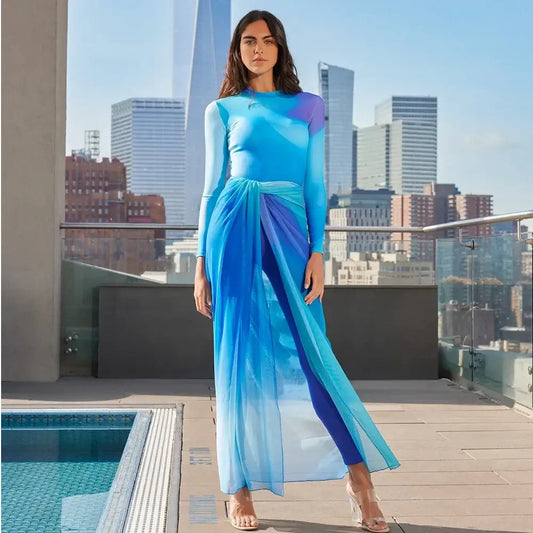 Muslim Modest Long Sleeve Burkini Swimwear for Women in Blue near a pool with city skyline in the background.