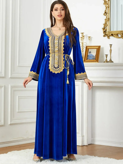 Woman in a luxurious blue Morocco party dress with intricate lace-up detailing, perfect for autumn and winter fashion.