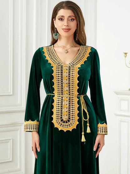 Woman wearing elegant Morocco Party Dress in green velvet with gold lace-up detailing, perfect for autumn winter occasions.